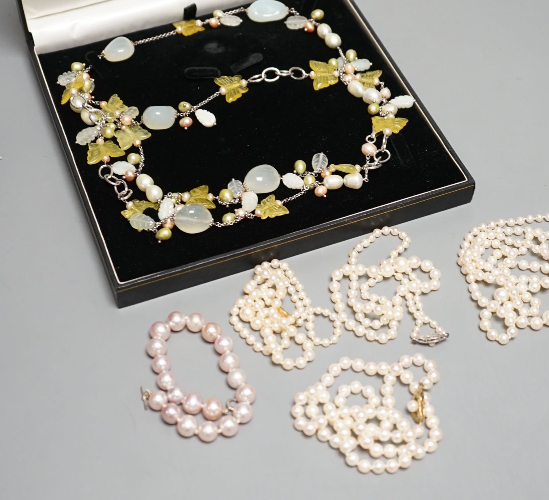 Four cultured pearl necklaces, including one double strand by Mikimoto, 46cm, three with 9ct gold clasps, one cultured pearl bracelet and two modern glass necklaces.